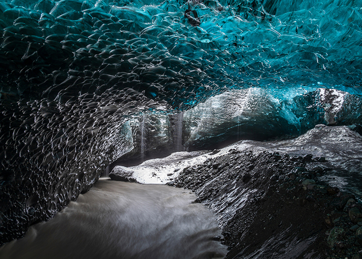 The screen vividly contrasts the intricate details of blue and dark tones within the cave.
